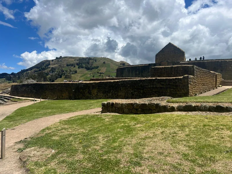Wide view of the Ingapirca Inca ruins with green Andean hills behind